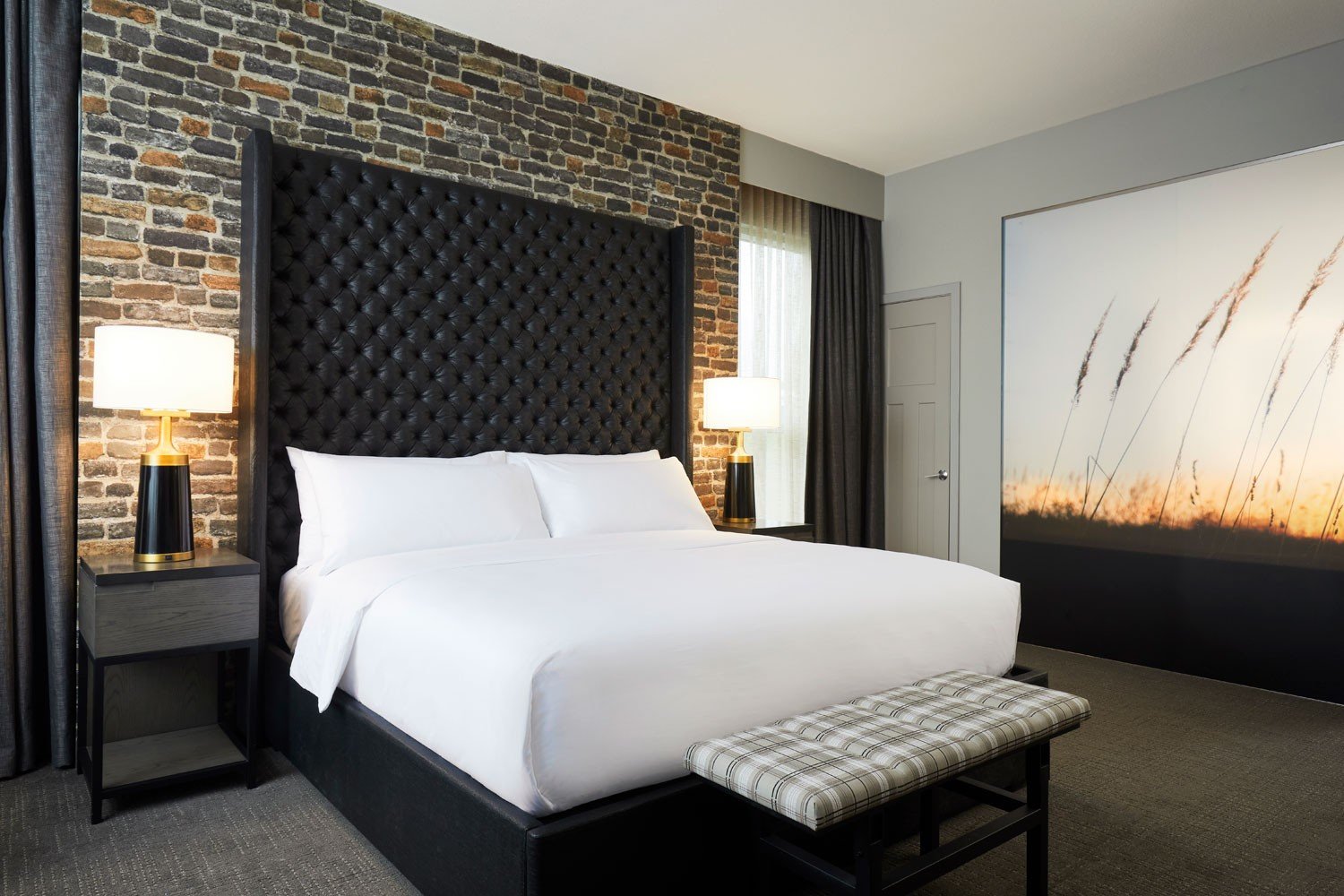 Archer Hotel Tysons - Archer's Den bed with exposed brick